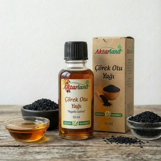 Soğuk sıkım organik çörek otu yağı şişesi ve çörek otu tohumları